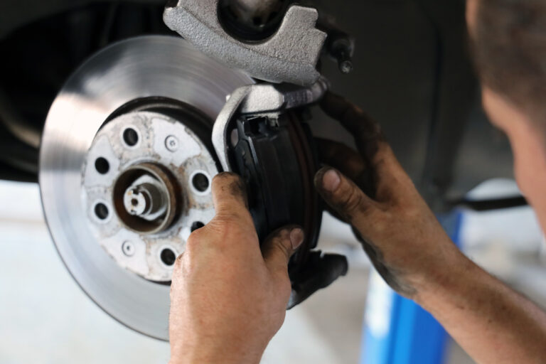Man's hands holding a vehicle brake.